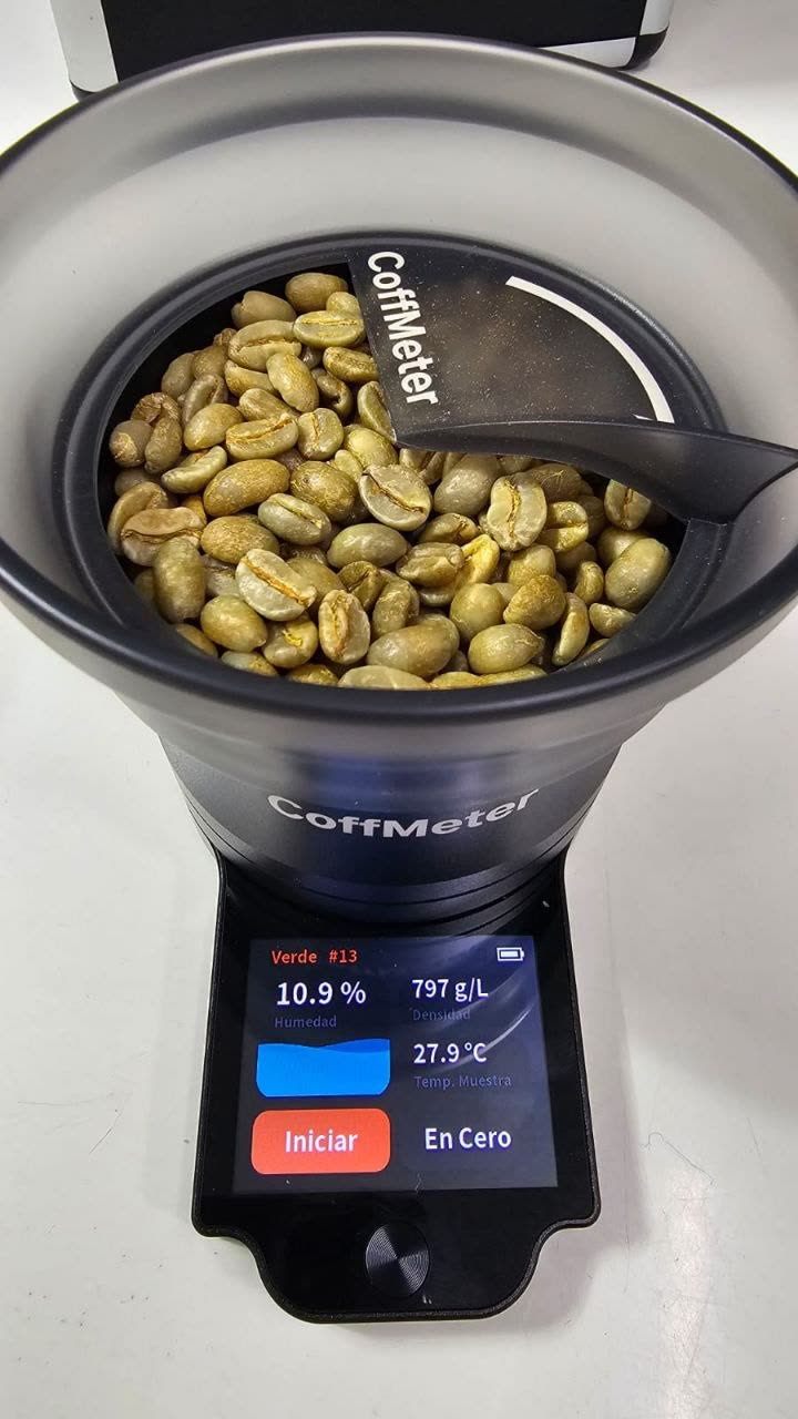 Quality control at origin — CoffMeter reading 10.9% moisture and 797 g/L density on a green coffee lot